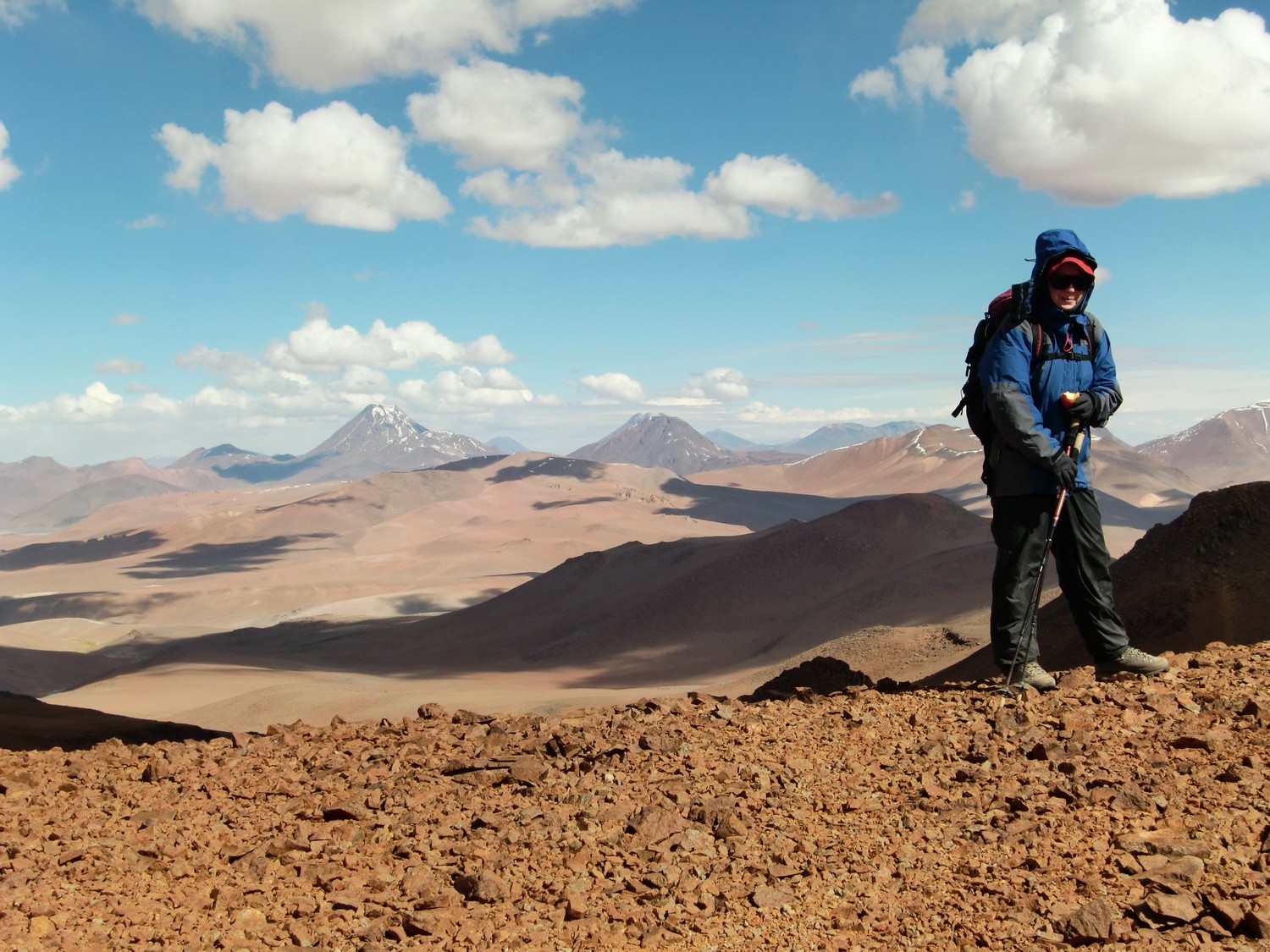 Marion on top of Cerro Incahuasi with Volcanoes Pili and Aguas Caliente in the background
